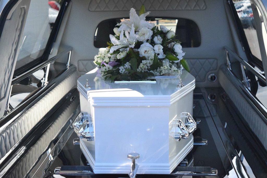 A funeral resting in the back of a hearse.