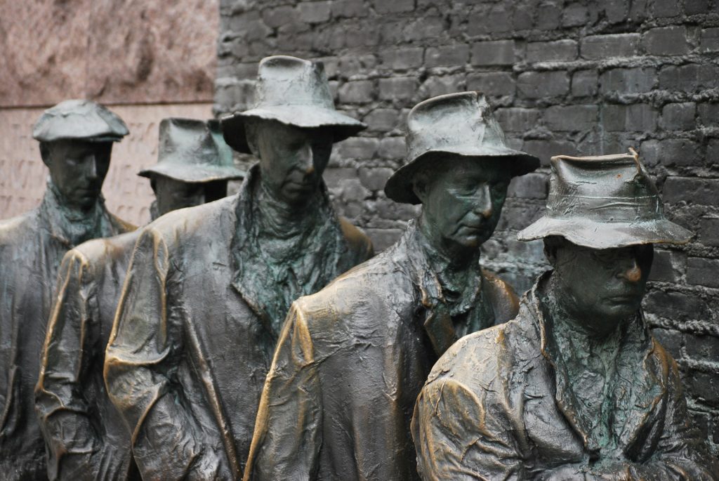 Statues forming a breadline.